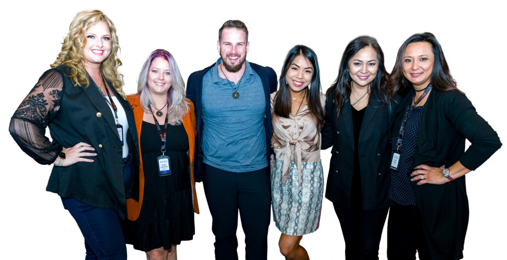 5 women and 1 man standing and smiling in semi-business attire; lovit